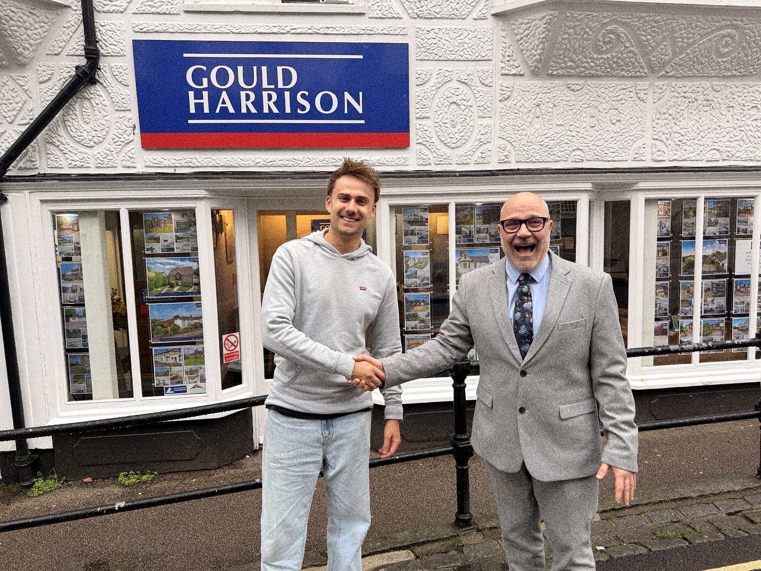 Fraser Mair of Wooma shaking hands with Tony Gilbert of Gould Harrison outside the agency's office in Ashford