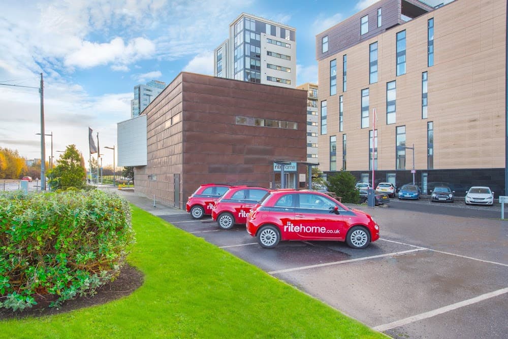Ritehome's branded red Fiat 500s parked outside its copper-clad headquarters at Glasgow Harbour