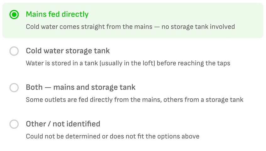 Wooma water supply type picker showing Mains fed directly selected, with Cold water storage tank, Both, and Other options below